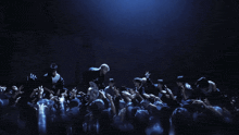 a man is being thrown in the air by a crowd of people