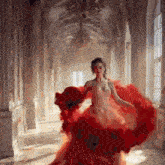 a woman in a long red dress is standing in a hallway