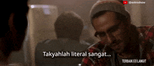 a man wearing glasses and a plaid shirt is talking to another man with the caption takyahlah literal sangat