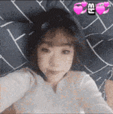 a girl with a cat ear headband is laying on a bed with a sticker that says sensei