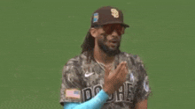 a baseball player wearing a jersey with the number 23 on it is standing on a field .
