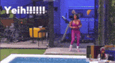 a woman in a pink jumpsuit is standing in front of a pool with the words yeih written on the bottom