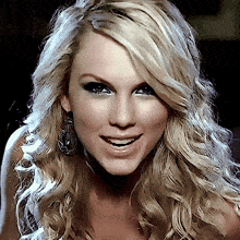 a close up of a woman 's face with blonde hair and earrings