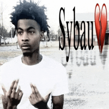 a young man in a white shirt is giving the middle finger in front of a sybau logo
