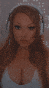 a woman wearing headphones and a white top