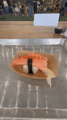 a plate of sushi with crab sticks on top of rice