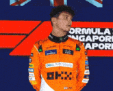 a man wearing an orange jacket that says dell technologies