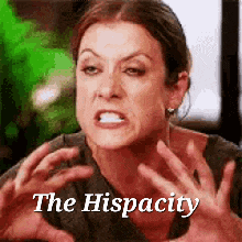 a woman is making a funny face and says `` the hispacity '' with her hands .