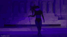 a woman in lingerie is holding a sword in front of a purple building .