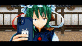 a girl with green hair is taking a selfie with a phone that says e on it