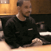 a man wearing a black sweater with the word columbia on the front