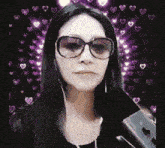 a woman wearing glasses and headphones is holding a phone