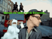 a man holding a stuffed animal with the words quando me falam mal do bolsonaro written above him