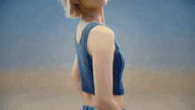 a woman wearing a guess crop top and jeans