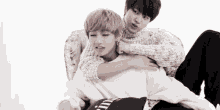 two young men are hugging each other and one of them is wearing a sweater that says ' a ' on it