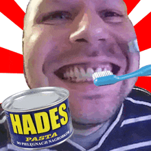 a man is brushing his teeth next to a can of hades