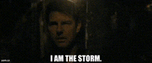 a close up of a man 's face with the words `` i am the storm '' written below him .