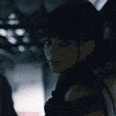 a close up of a woman 's face with dark hair