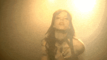 a woman 's face is visible through a smokey background