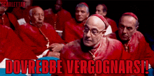 a group of cardinals are sitting in a dark room with the words dovrebbe vergonnarsi written above them