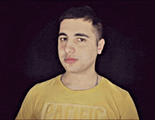a man wearing a yellow t-shirt with the word united on it