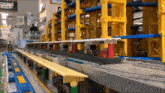 a toy train is going down the tracks in a building .