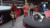two women in a wrestling ring with the word raw on the wall