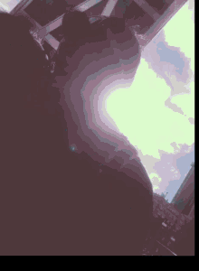 a blurry picture of a person 's face with a purple sky in the background