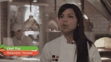 a woman in a chef 's uniform with the name chef tita on the top