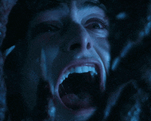 a close up of a man 's face with his mouth wide open