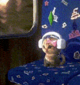 a puppy wearing headphones and a pink bow on its head