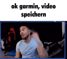 a man is standing in front of a computer screen with the words `` ok garmin , video speichern '' .