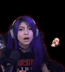 a woman with purple hair is wearing headphones and a t-shirt that says resident evil .