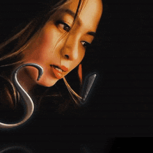 a close up of a woman 's face with the letter a in the foreground