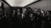 a man in a suit and tie is being photographed