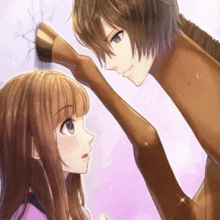 a boy and a girl are touching each other 's faces