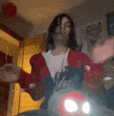 a woman in a red jacket and white shirt is sitting on a motorcycle .