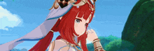 a girl with red hair and blue eyes is standing in front of a mountain .