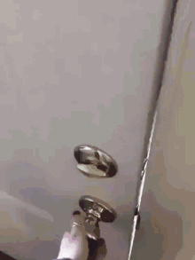 a close up of a person 's feet hanging from a ceiling