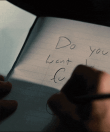 a person writing in a notebook that says do you want c