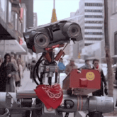 a robot with a red bandana and a smiley face