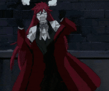 a man with red hair and glasses is standing in front of a brick wall with his arms in the air