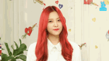 a girl with red hair is wearing a white shirt and giving a peace sign