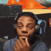 a man wearing headphones is making a funny face while looking at the camera .