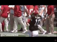 a football player with the number 17 on his jersey is kneeling down on the field .
