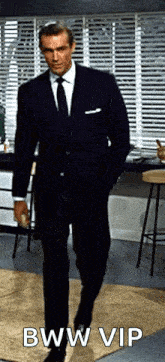 a man in a suit and tie is walking with his hands in his pockets and the caption bww vip