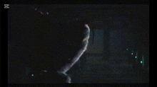 a person is walking down stairs in a dark room with a blurred background .