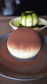 a dessert on a plate with a green sauce on it