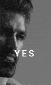 a black and white photo of a man with the word yes written on it