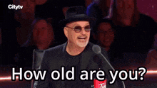 a young boy singing into a microphone with the words " im 4 years old " below him